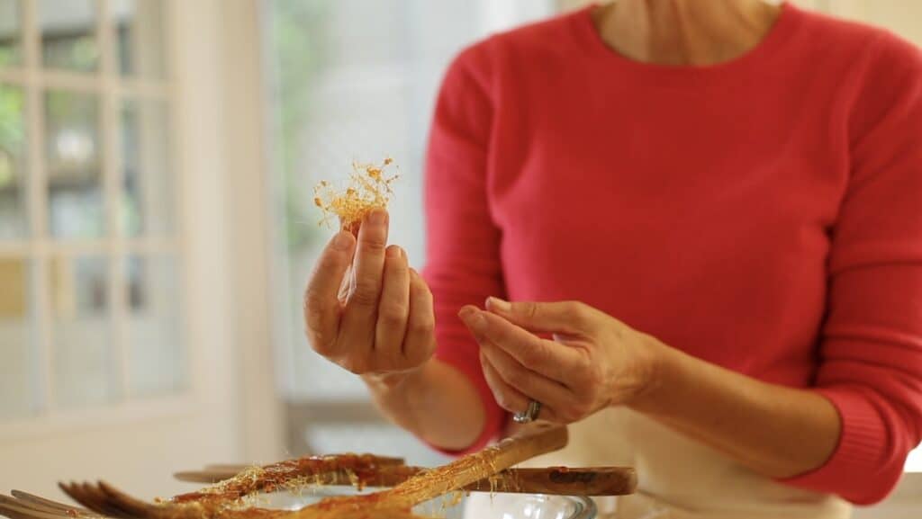 a person holding a ball of spun sugar