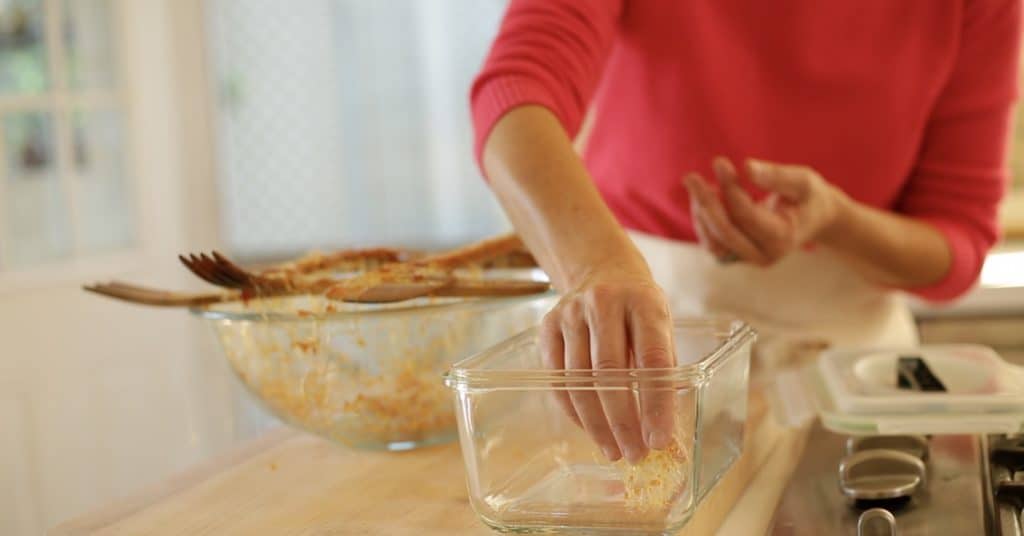 Placing spun sugar garnishes in a glass container