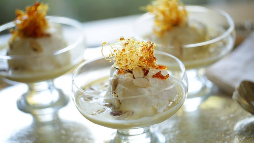 Ile Flottante in glass footed bowls on silver tray with spun sugar ganrishes