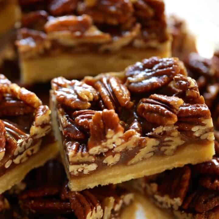 Pecan Bars with Shortbread Crust sliced into bars on a cake stand