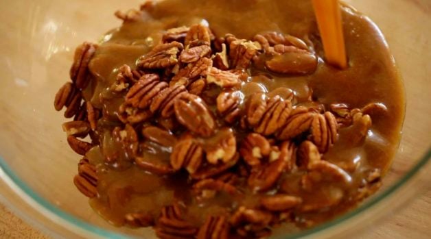 Pecan filling in a large clear bowl