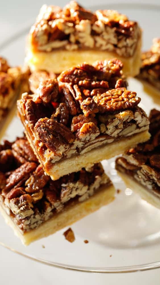 Pecan Squares piled ion a cake stand.