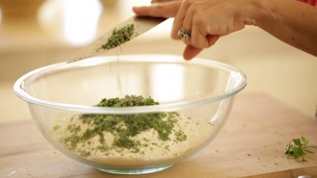 mixing fresh herbs into flour mixture