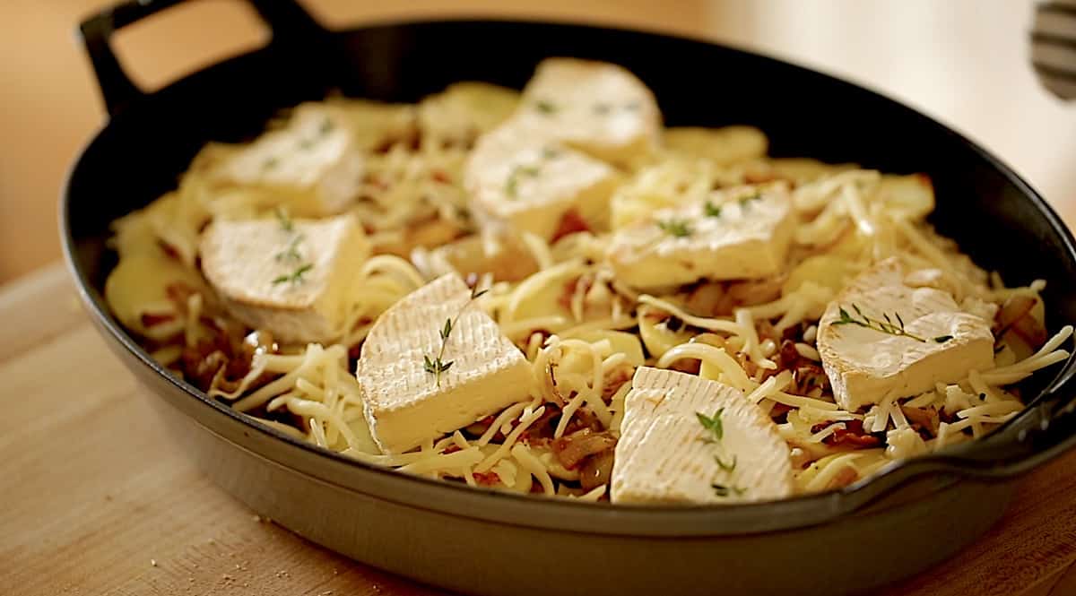 Fresh tyhme and brie on top of a potato casserole