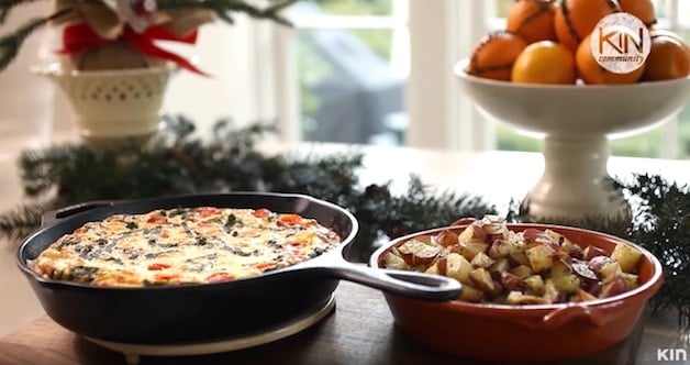 Frittata in a skillet served with roasted potatoes on a Christmas themed breakfast table