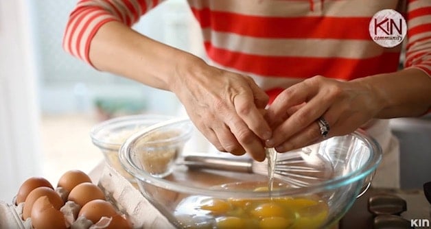 Cracking eggs into a glass bowl for Frittata