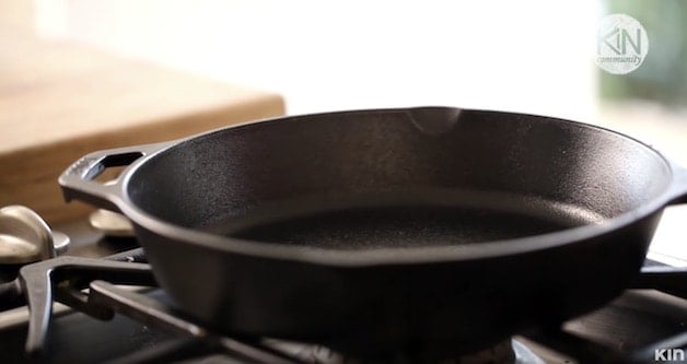 Tight shot of a cast-iron skillet on a cooktop