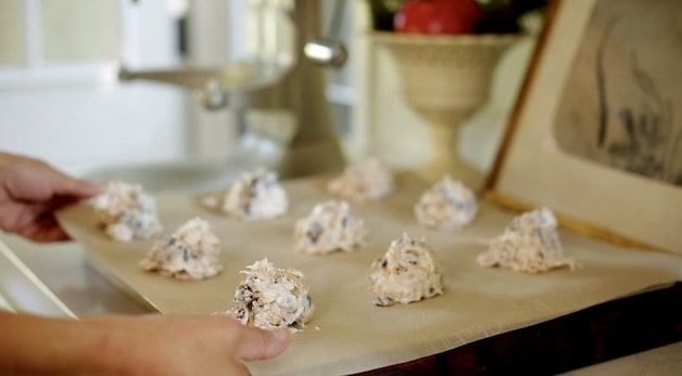 Cookie dough spooned out oto parchment lined cookie sheet