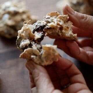 Cookie being pulled apart to show the texture of cocunut, chocolate chip and cornflakes