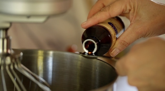 Adding vanilla to a bowl of an electric mixer