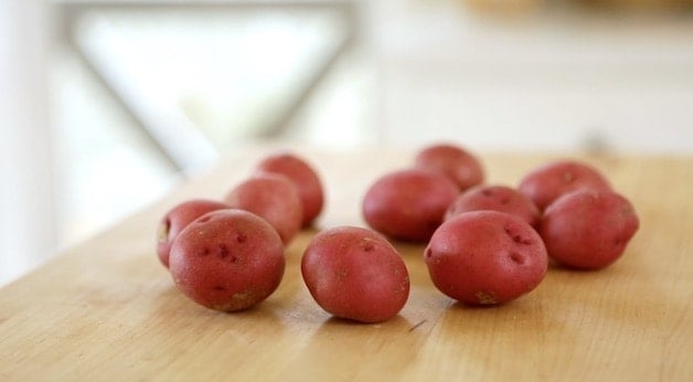 red potatoes on wood cutting board