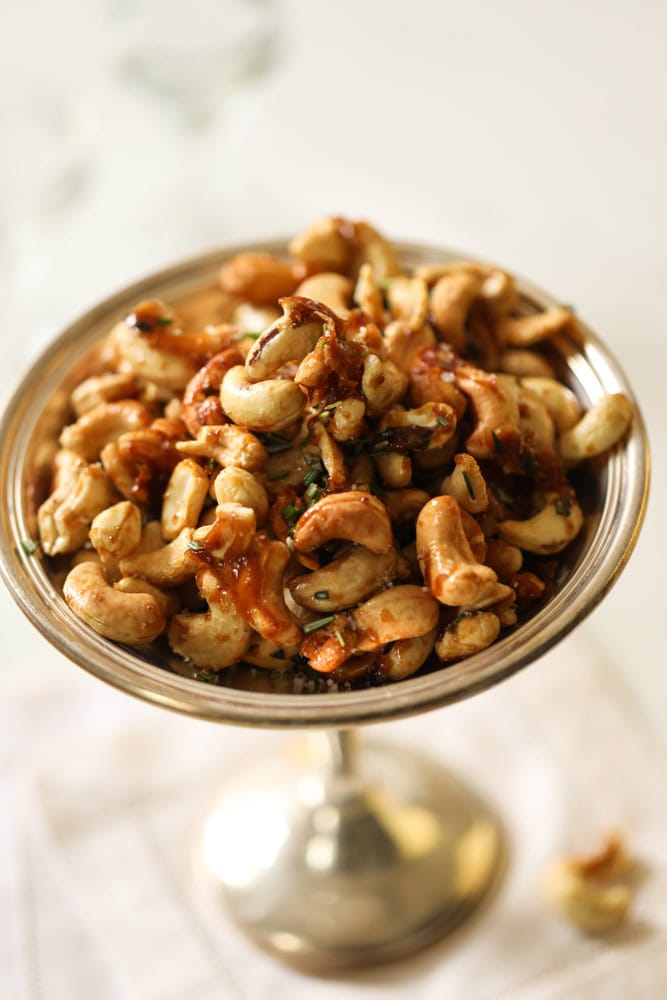 honey roasted cashews in a silver candy dish.