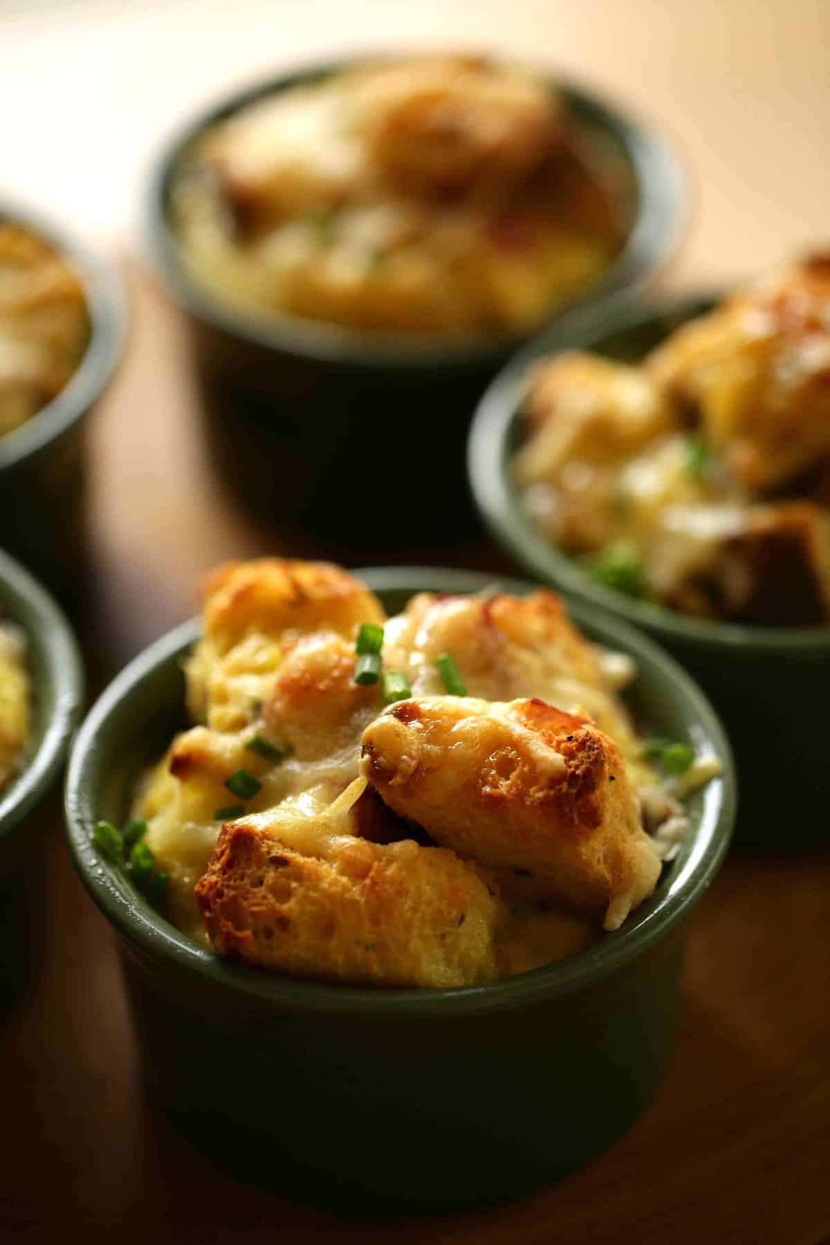 a vertical image of mini egg casseroles in ramekins