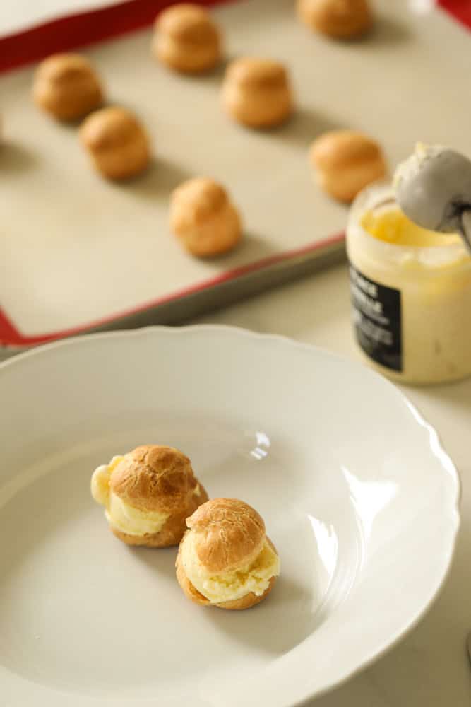 filling choux pastry shells with ice cream.