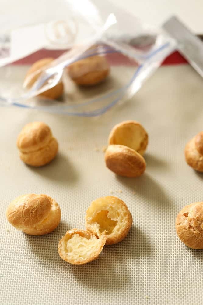 placing choux pastry shells in a freezer bag for freezing.