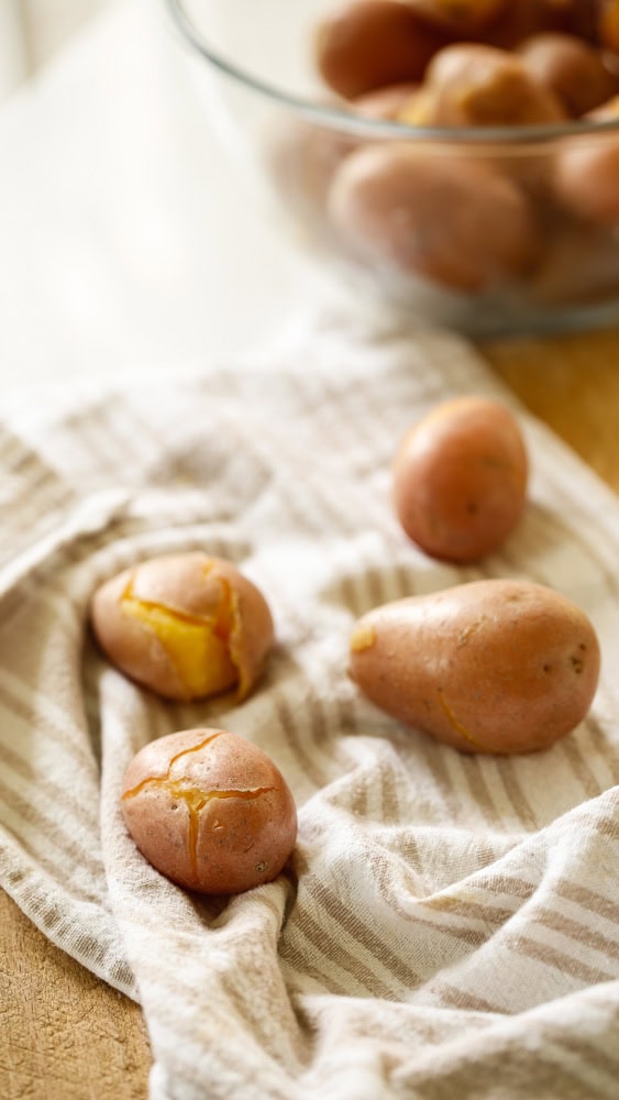 Potatoes wrapped in dish towel to dry them. 