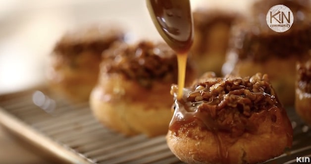 Pouring sticky sauce on sticky buns