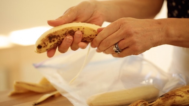 Peeling ripe Bananas and placing them in a zip lock bag for the freezer