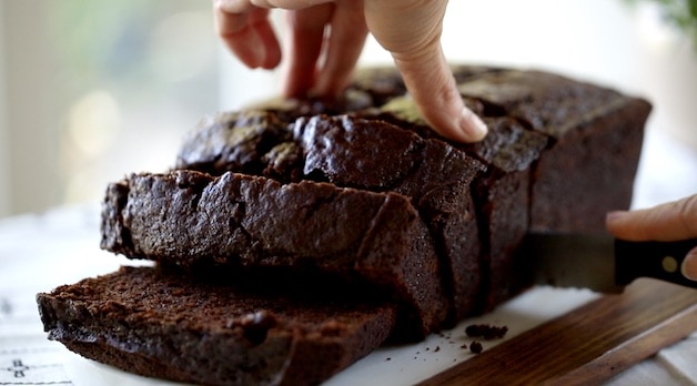 Slicing Chocolate Banana Bread into thick slices with a bread knife