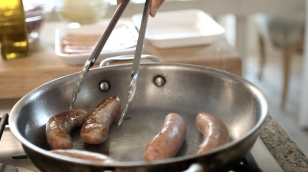 Browning sausages in pan