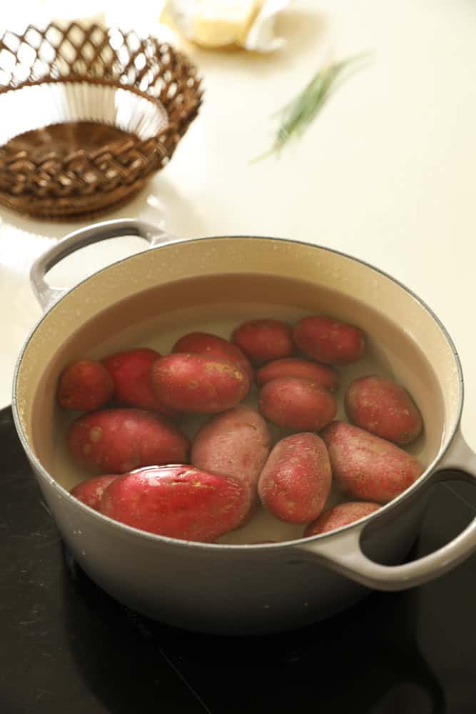 red potatoes set to boil in a large Dutch oven.