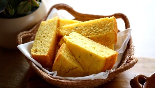 Cornbread wedges in a basket lined with a white napkin