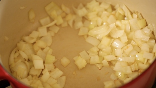 Onions sautéing in a large soup pot