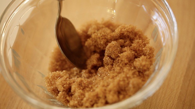 Brown sugar in a glass bowl with a spoon