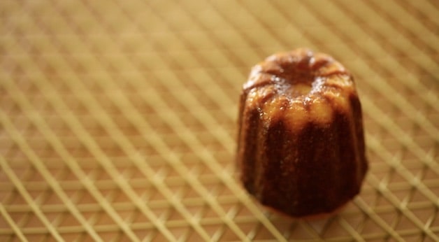 Single Canele on a cooling rack