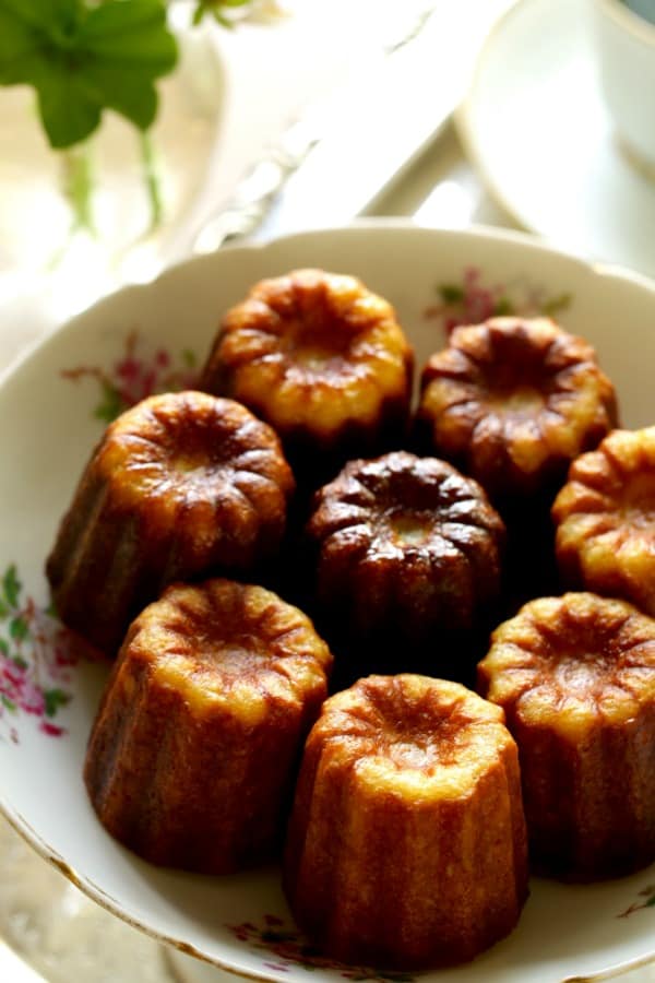 Vertical Image of a Caneles in a floral cake dish