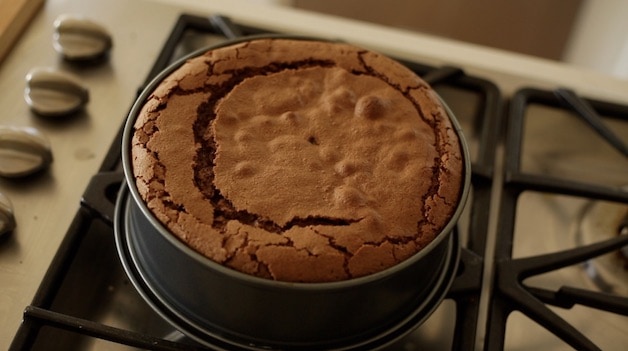 Overhead shot of a flourless chocolate cake on a cooktop