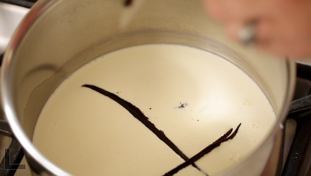 Vanilla Bean Pods simmering in a pot of milk