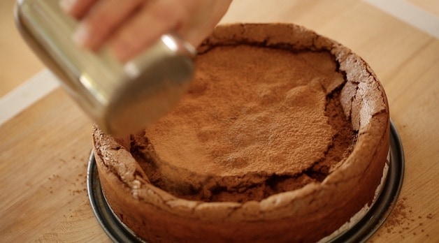 Dusting Flourless Chocolate Cake with Cocoa Powder