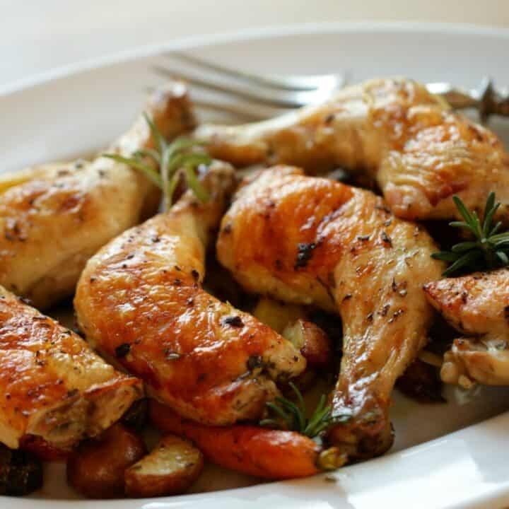 Roasted Chicken Legs and Vegetables on a white Platter
