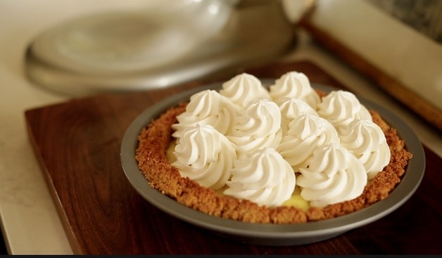 A cococut cream pie ready to be set in the refrigerator