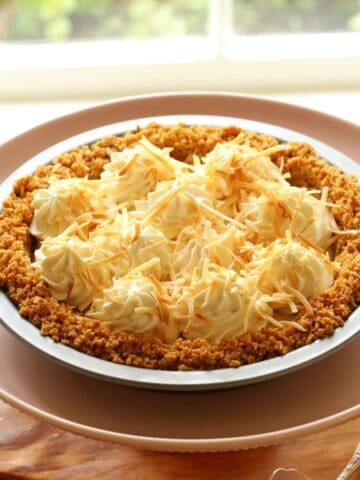 Coconut Cream Pie on a pink cake stand