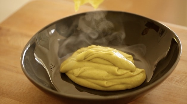 pistachio pastry cream cooling in a black dish