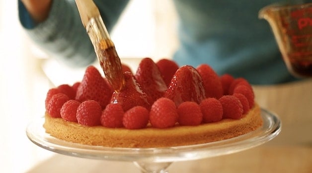 Brushing Strawberries with strawberry jelly