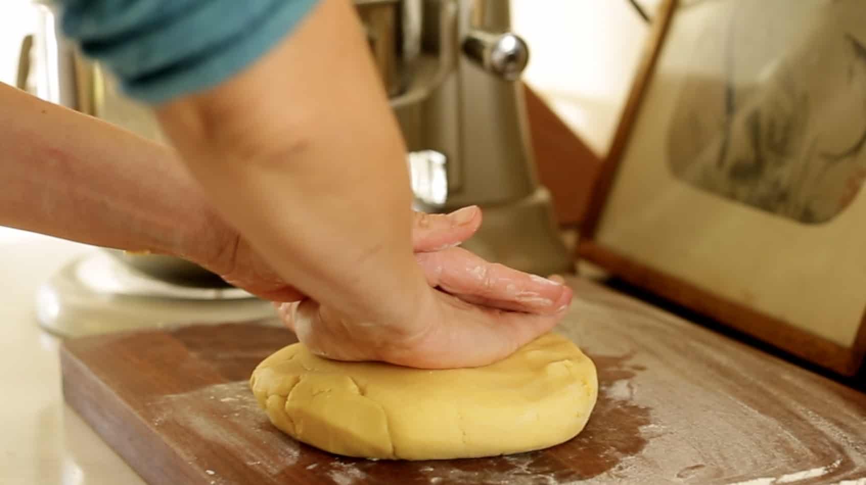 pressing sable breton dough into a disc