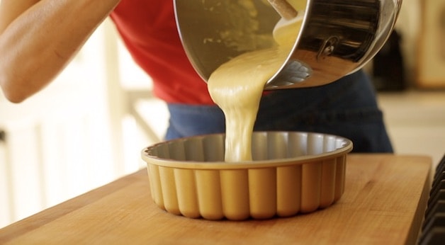 pouring cake batter into a Charlotte Cake Mold