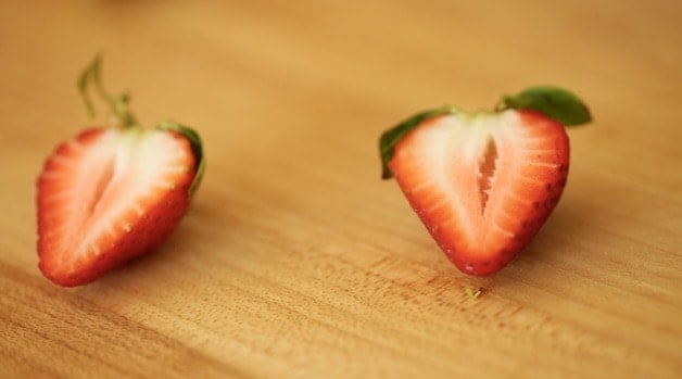 Sliced strawberries on a cutting board