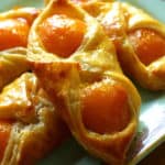 A close up of an apricot pastry on a plate