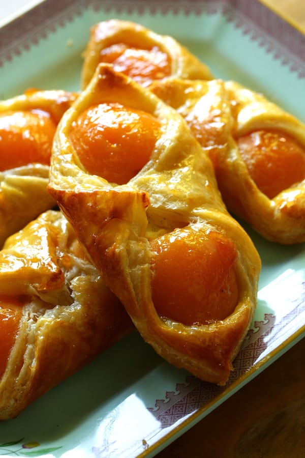 A close up of an apricot pastry on a plate