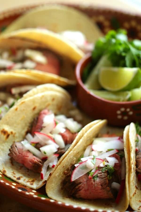 Carne Asada Tacos on a large terra cotta platter