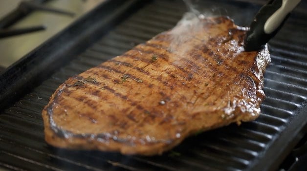 Grilling Flank Steak on a large indoor grill pan