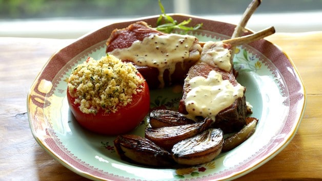Slow Roasted Lamb Chops with Carmelized Shallots and Roasted Tomato on a green floral Plate