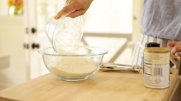 Adding flour to a bowl