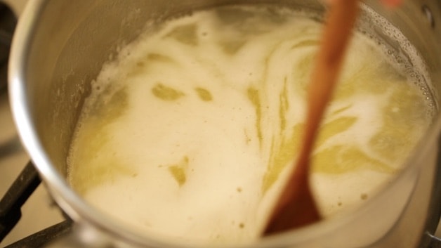 Stirring melted butter and water in a pot
