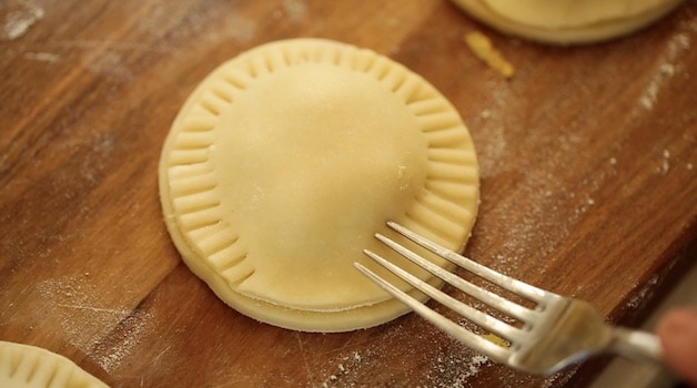 creating hand pie seal with a floured fork 