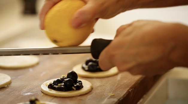 Adding lemon zest to blueberry hand pie filling